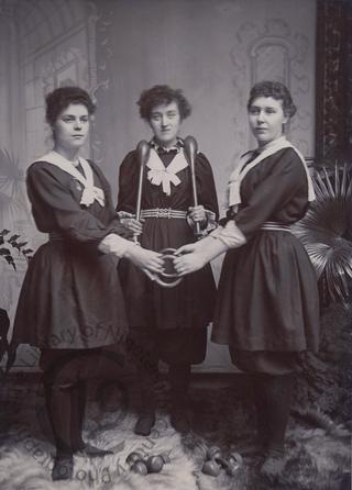 Three women with exercise equipment