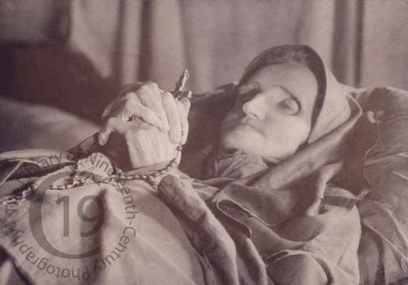 An elderly woman with a rosary