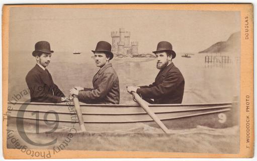 Three men in a fake rowing boat