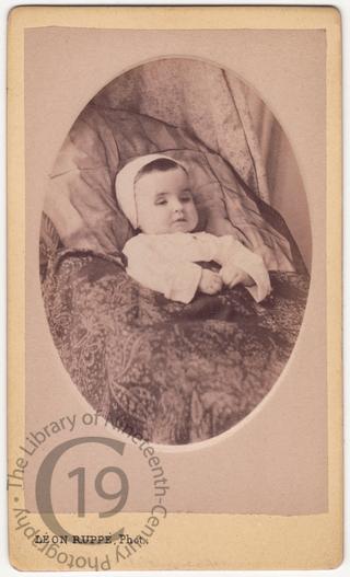 An infant in a baby bonnet 
