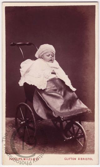 A baby in a pushchair