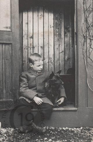 A small boy with a Scottish Terrier