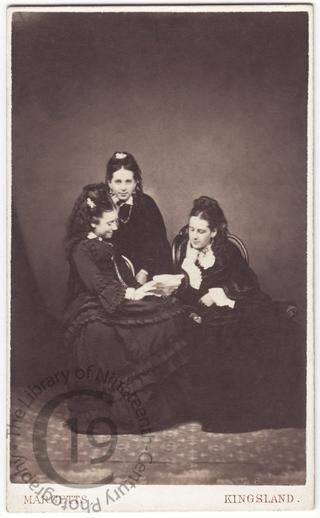 Three girls reading a letter