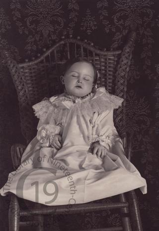 Young girl in wicker chair