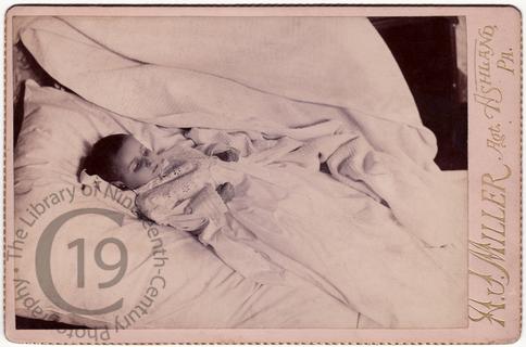 Infant in christening gown