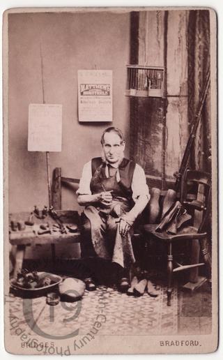 A cobbler mending shoes
