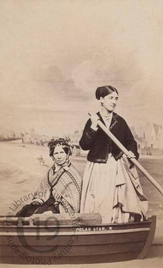 Two women in a fake rowing boat