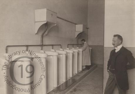 Two men in a urinal
