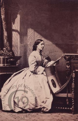 Miss Francis with portfolio of photographs