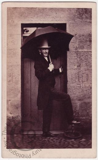 Unidentified man with umbrella