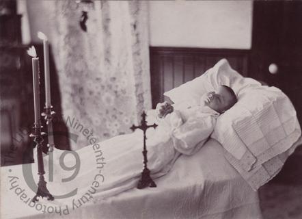 Child with cross and candels