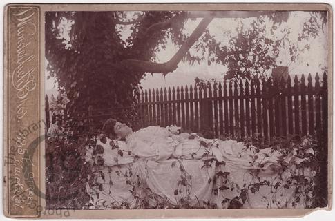 Woman by garden fence